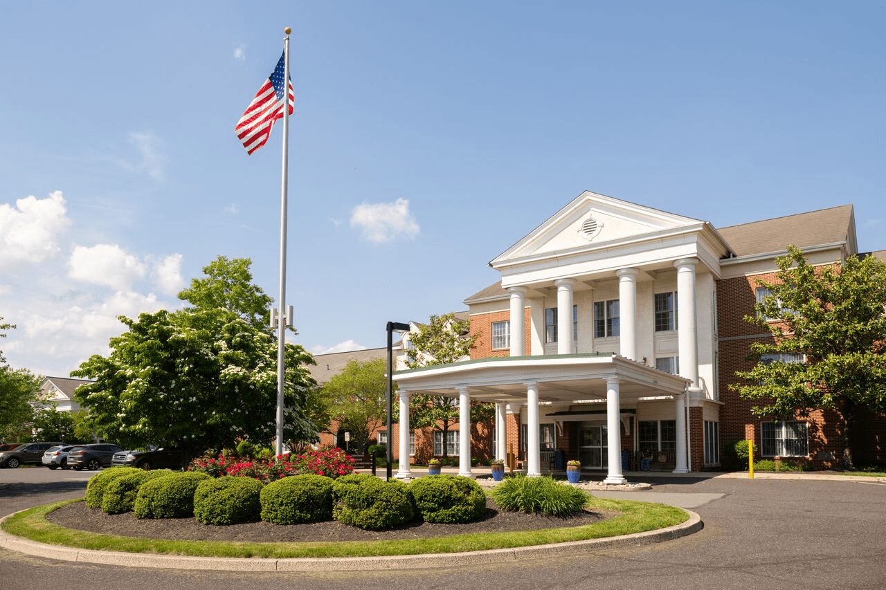 Welcoming main entrance of a community building with white columns, the first stop for retirement lifestyle information.